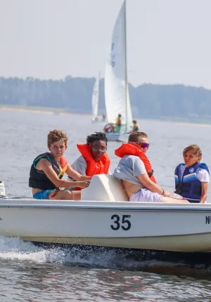 Four boys on a motorboat